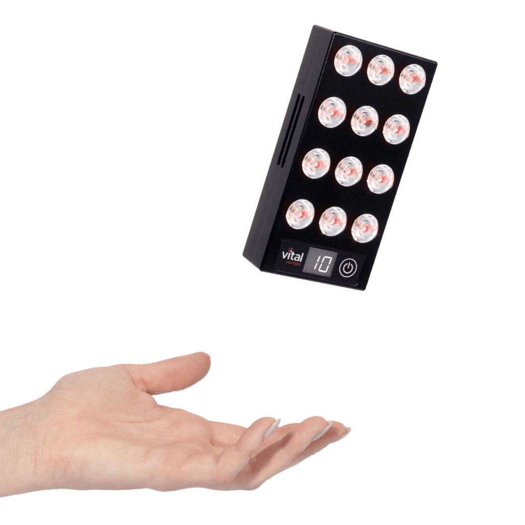 A sleek black rectangular device with circular lights, showcasing the number 10 and an illuminated power button, hovers above an open hand. This innovative gadget hints at potential red light therapy benefits for enhanced wellness.