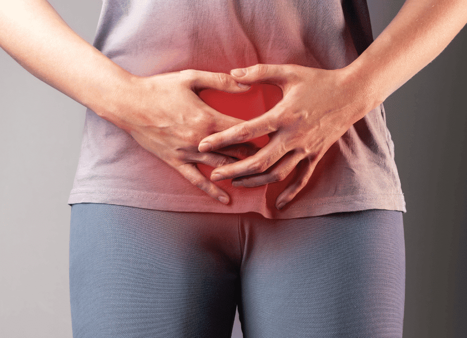 A person clutching their lower abdomen, highlighting discomfort with a red glow that seems to question, "What is red light therapy?.
