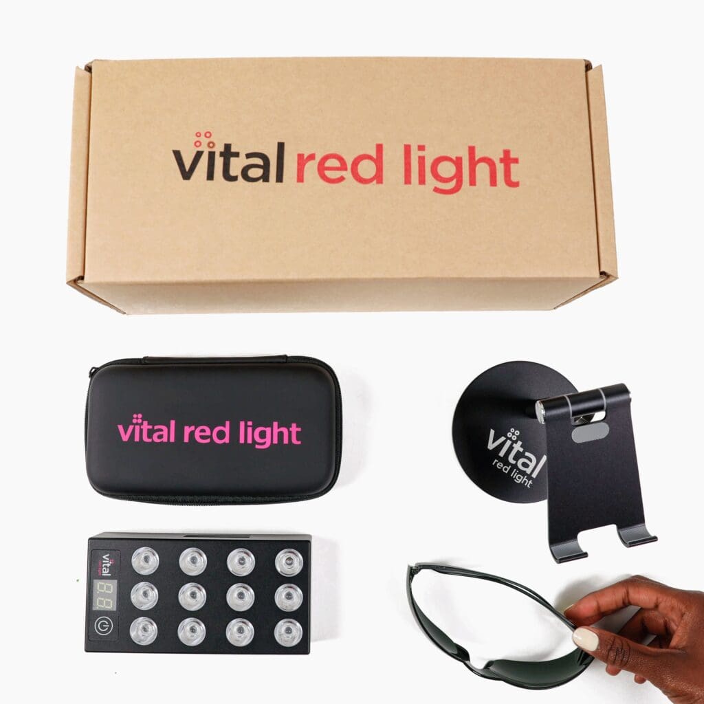 The Vital Red Light Therapy Kit, Perfect Christmas Gift, Red Light Skin Care Present, comes in a brown box with a sleek black carrying case. It includes a high-quality light device, protective glasses, and a sturdy stand.