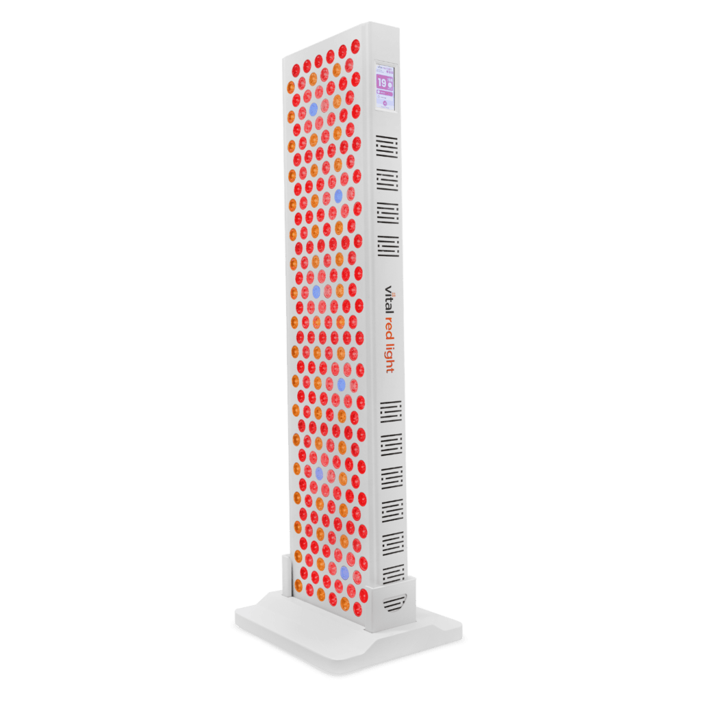 Introducing Vital 2.0: a tall vertical light therapy panel with numerous red lights on a sleek white base, proudly displaying "vital red light" on the side. This new product line seamlessly combines innovation and design for enhanced wellness.